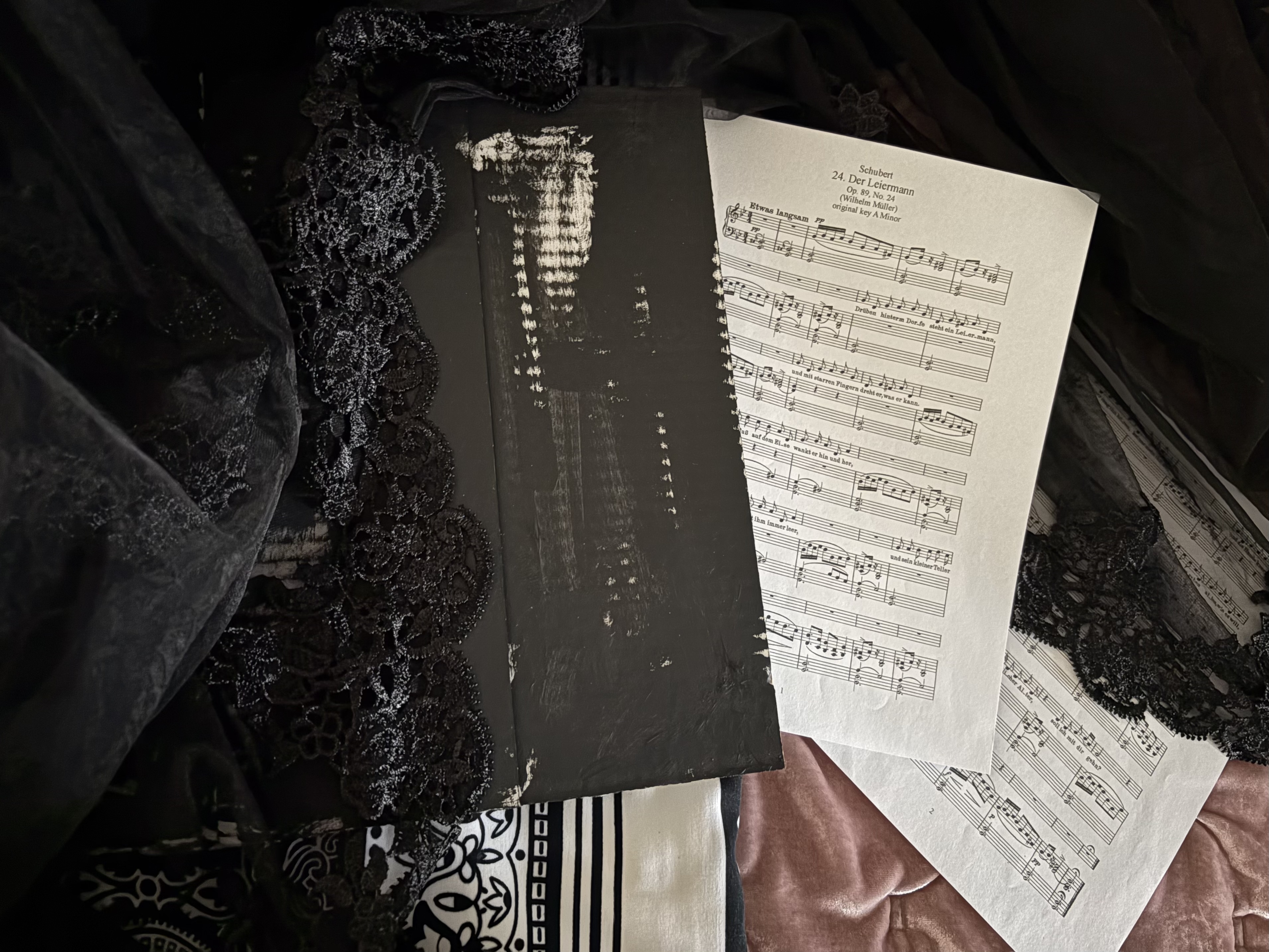 My sheet music for "Der Leiermann" from Schubert's Winterreise and my book of fragmented text.